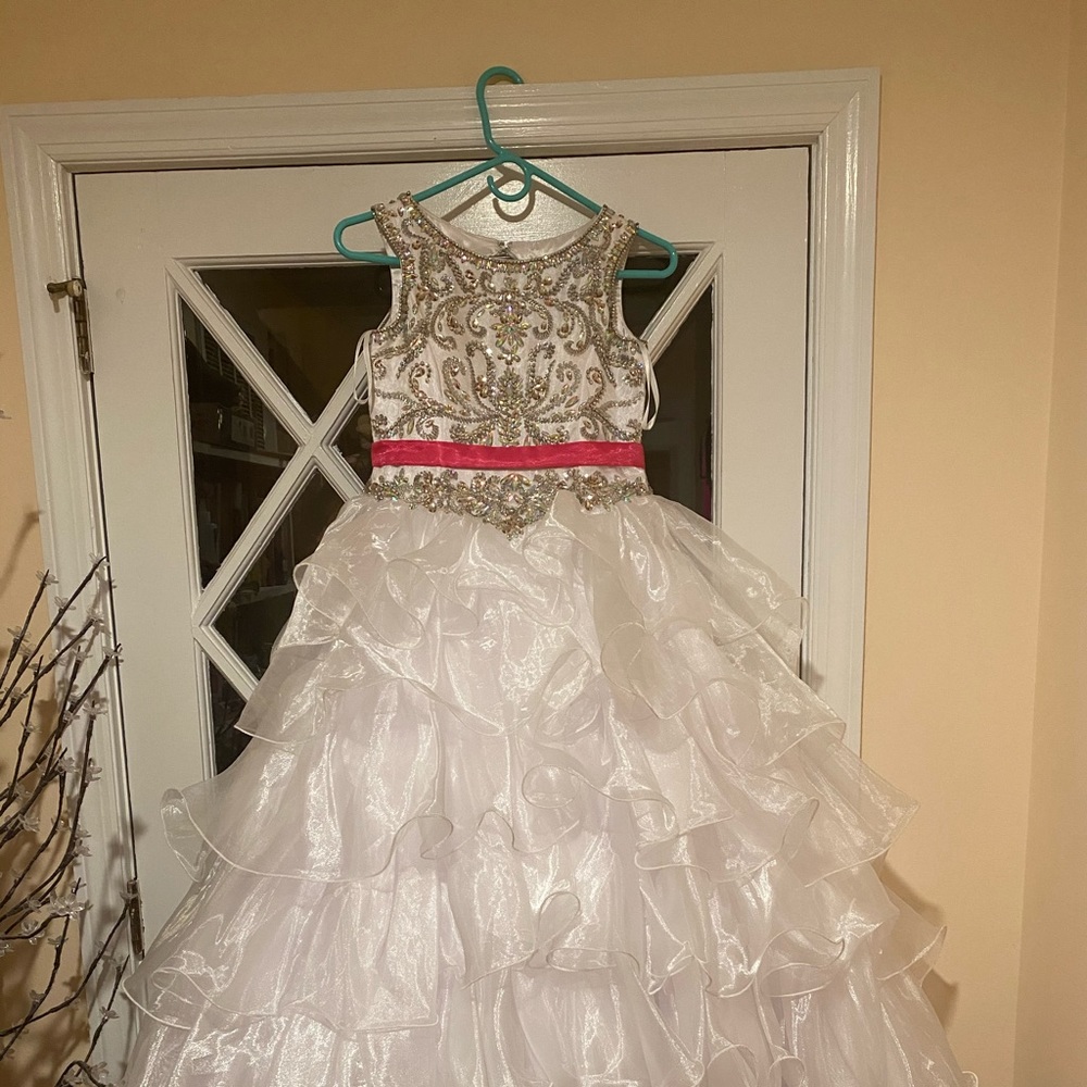 White gown,hot pink sash.  Approximately size 10.